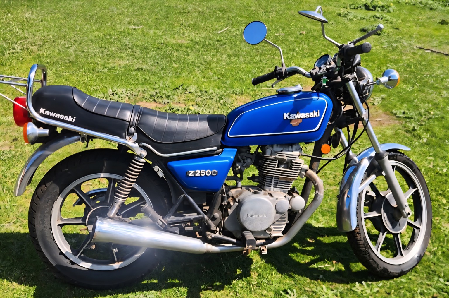 Blue 1981 Kawasaki Z250C with a black seat, chrome exhaust and alloy wheels
